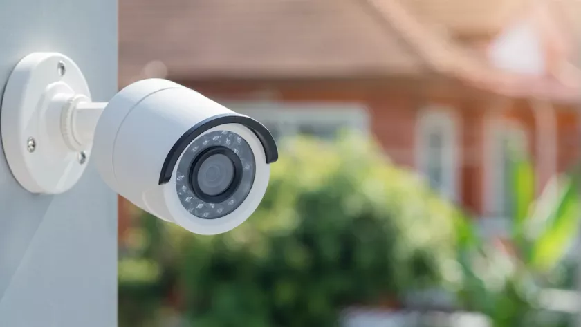 Home security camera on the outside of a house with a neighbour's house in the background