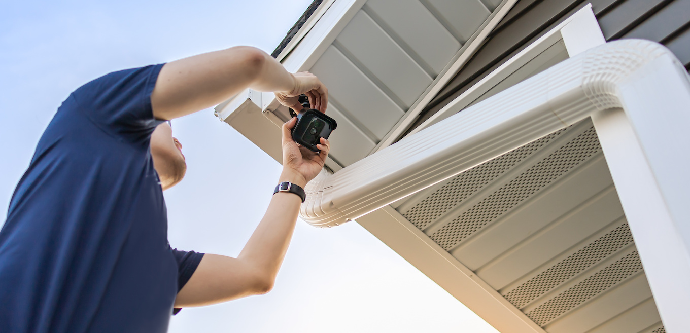 home security camera installer installing an outdoor CCTV system