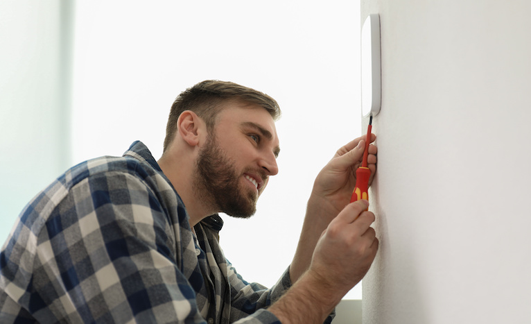 Man repairing an alarm system in Perth