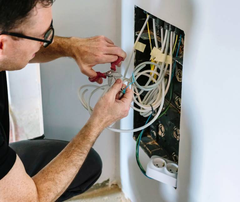 Data points & cabling being examined by a DeltaPrime team member