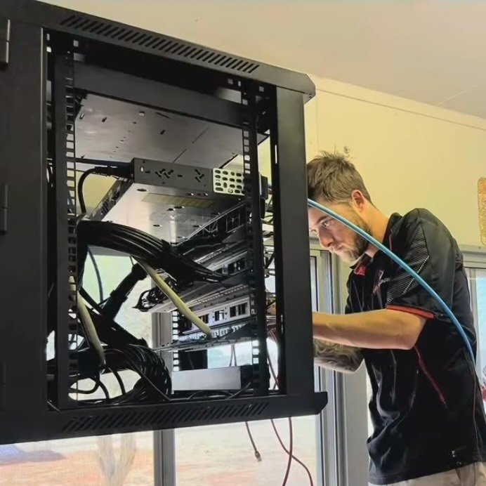 Electrician installing a multi-hub data point in a school